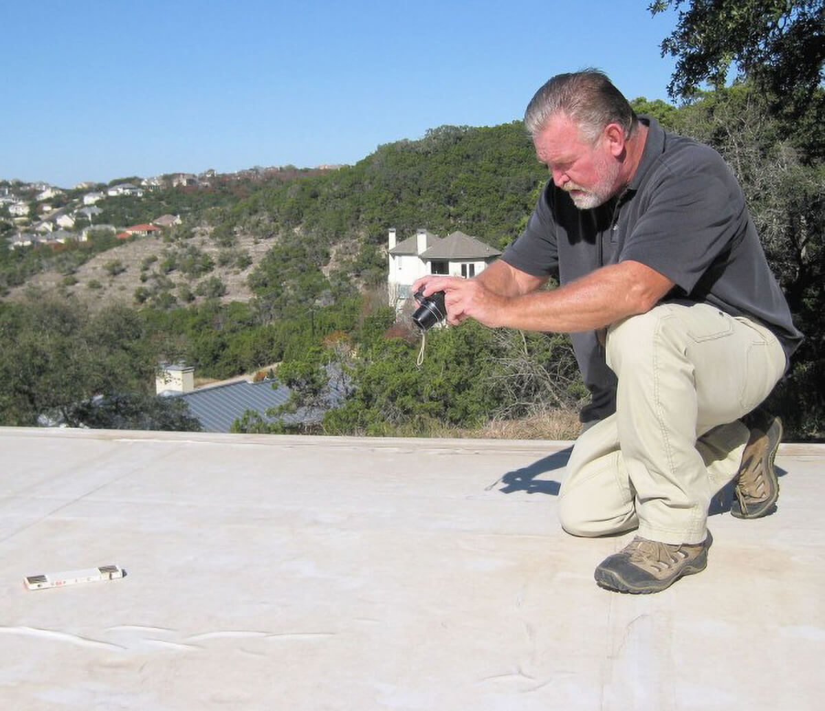 Don Putnam roof consultant inspecting a roof.
