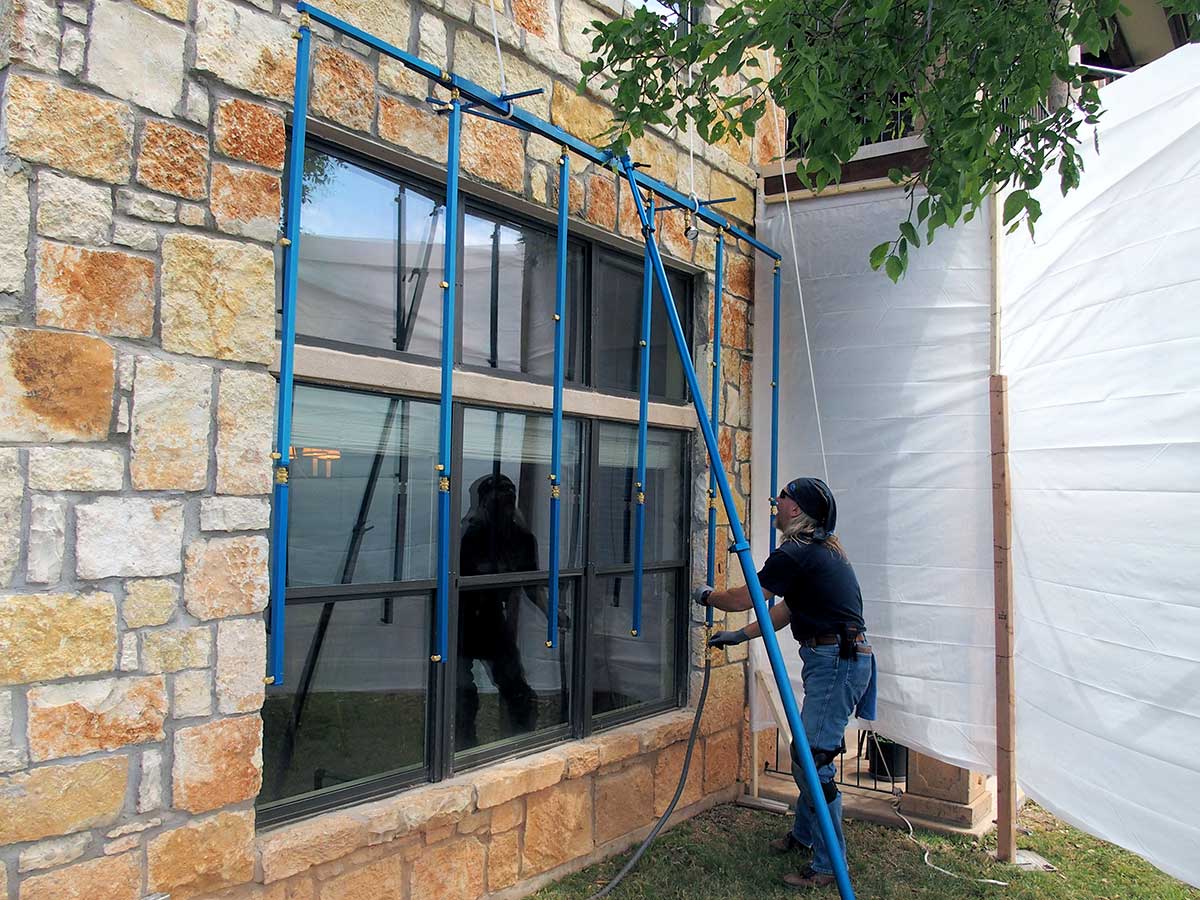 Roof consultant using a Rain Maker Spray Rack for testing.